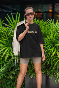 Woman wearing Labubu limited edition shirt oversized black tee styled with beige jacket outdoors