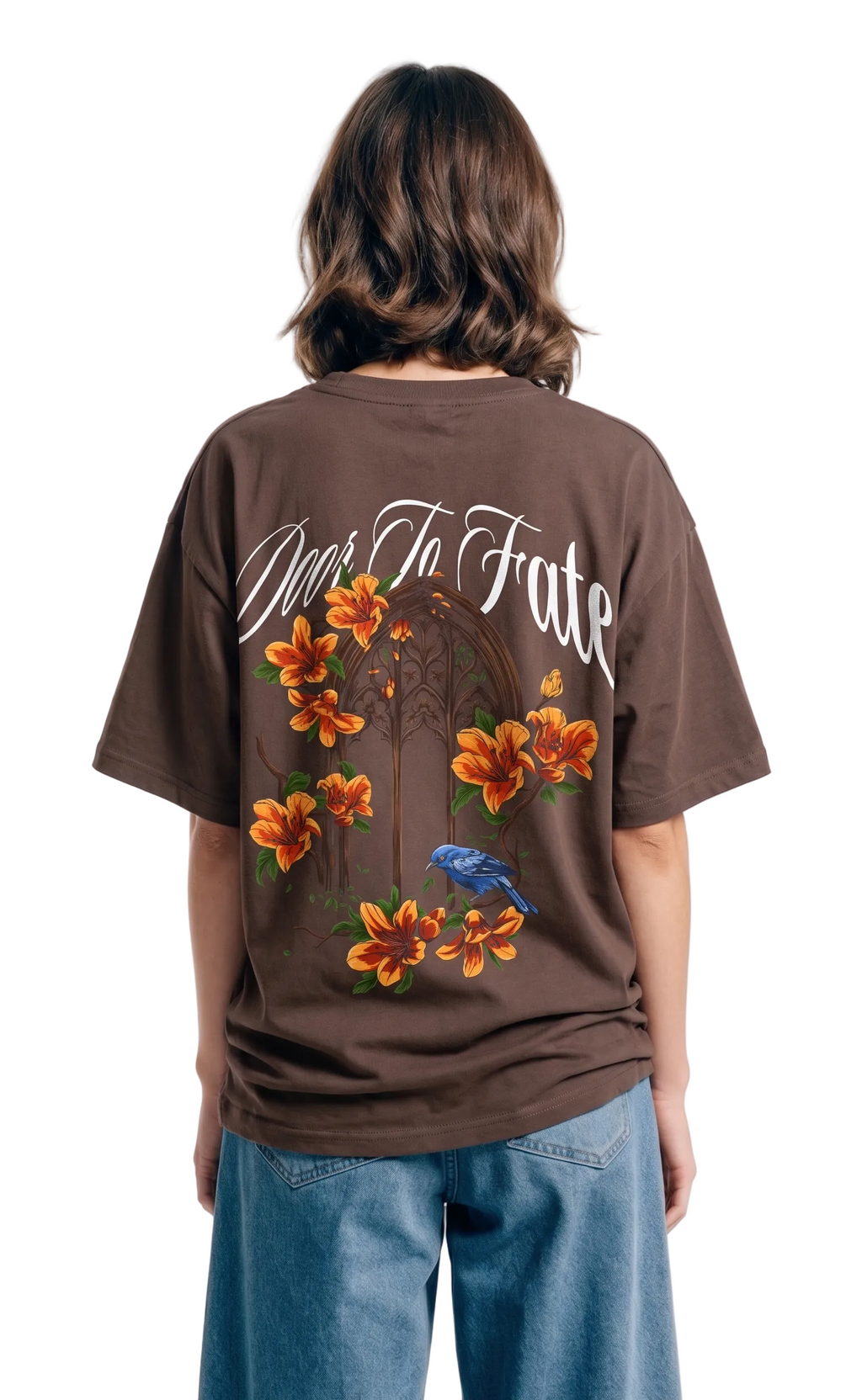 Person wearing a brown t-shirt with floral designs and text on the back, standing against a white background.