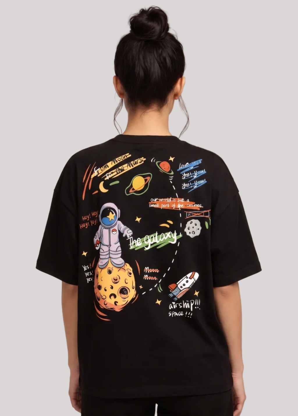 Person wearing a black t-shirt with space-themed graphics on the back