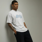 Man wearing a white t-shirt with blue text and black pants against a plain background