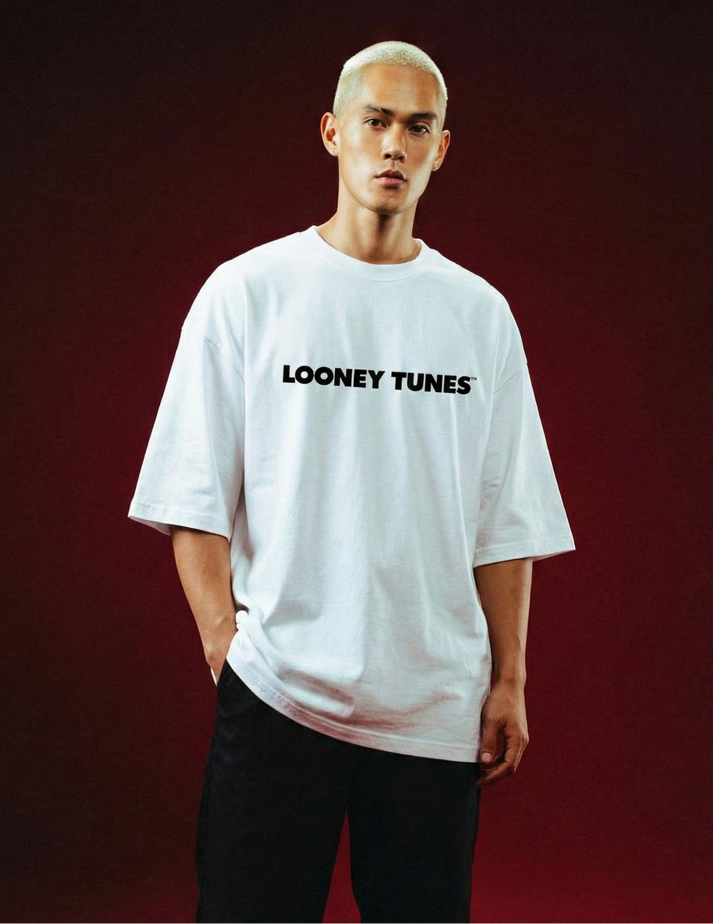 Person wearing a white 'Looney Tunes' t-shirt on a red background