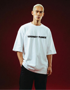 Person wearing a white 'Looney Tunes' t-shirt on a red background