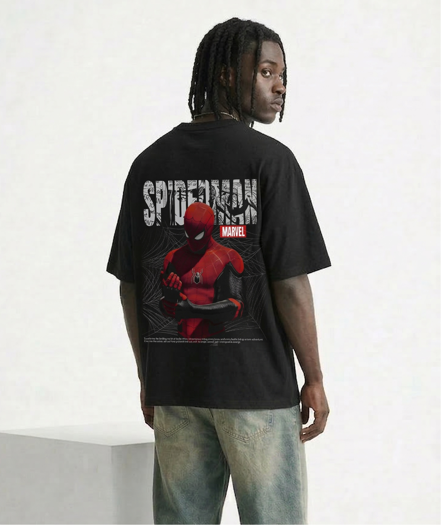 Person wearing a black Spider-Man t-shirt with a graphic design on a white background