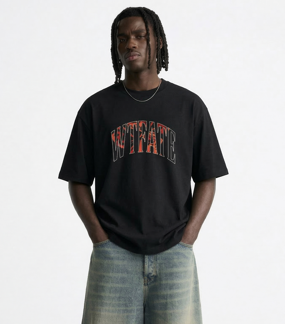 Person wearing a black t-shirt with colorful text and light blue jeans on a white background