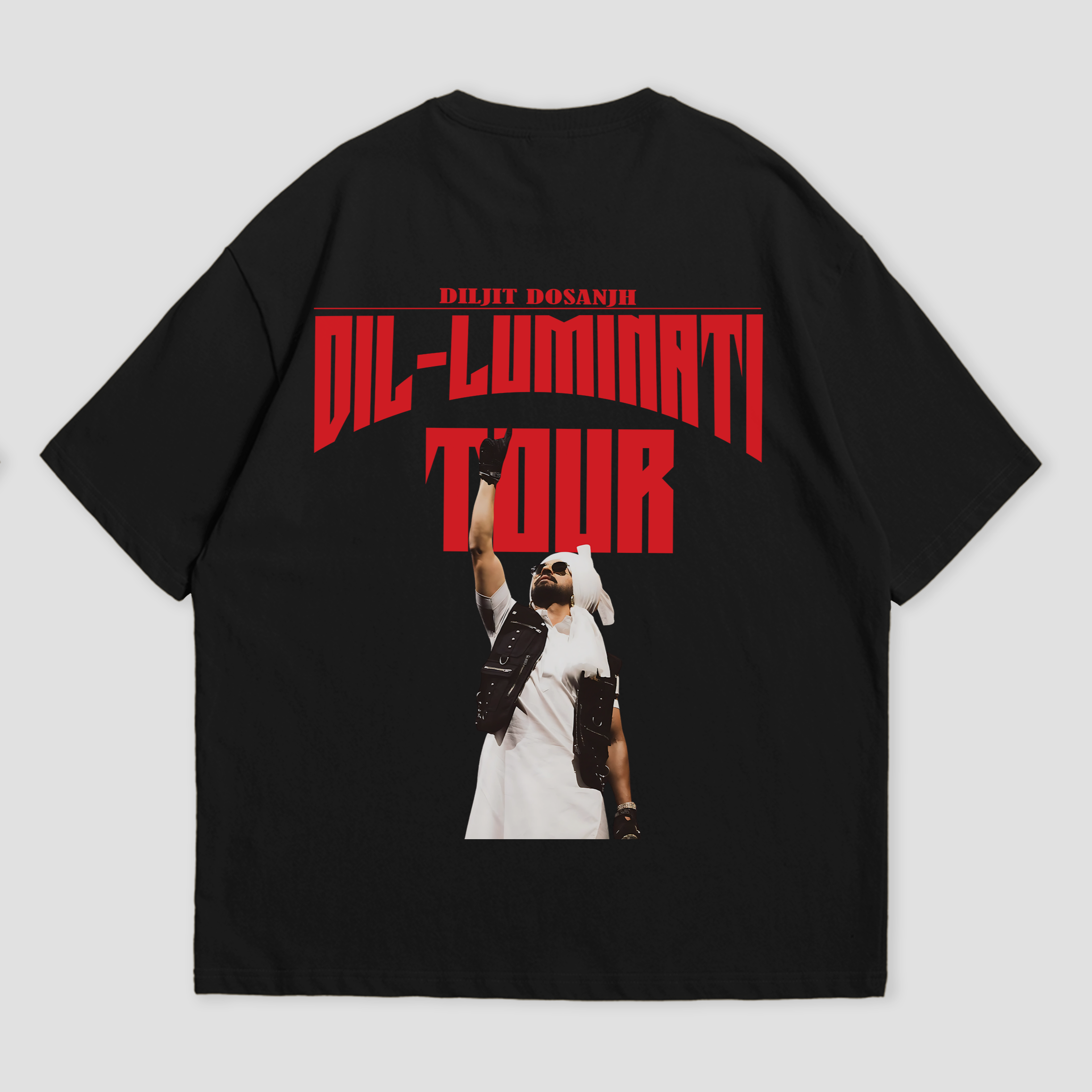 Back view of oversized black T-shirt by WHAT THE FATE with "Dil-Luminati Tour" graphic, showcasing a Diljit Dosanjh image. Perfect for music lovers and Diljit fans looking for unique tour merchandise and casual wear.