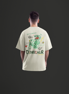 Person wearing a beige t-shirt with a colorful dinosaur graphic on the back against a black background