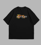 Black t-shirt with floral design and text on front and back against a gray background
