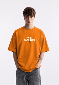 WHAT THE FATE oversized t-shirt in orange featuring The Fate Club graphic design