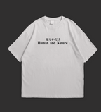 Two white t-shirts with a bonsai tree design and text on a black background