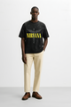 Nirvana Angel oversized tee in black featuring bold yellow lettering and a graphic design