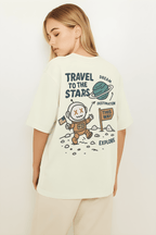 Travel to the Stars Oversized t-shirt featuring a playful astronaut graphic and directional sign