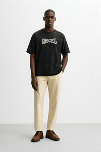 Man wearing a vintage angelic oversized shirt in black with the word Angel printed on it