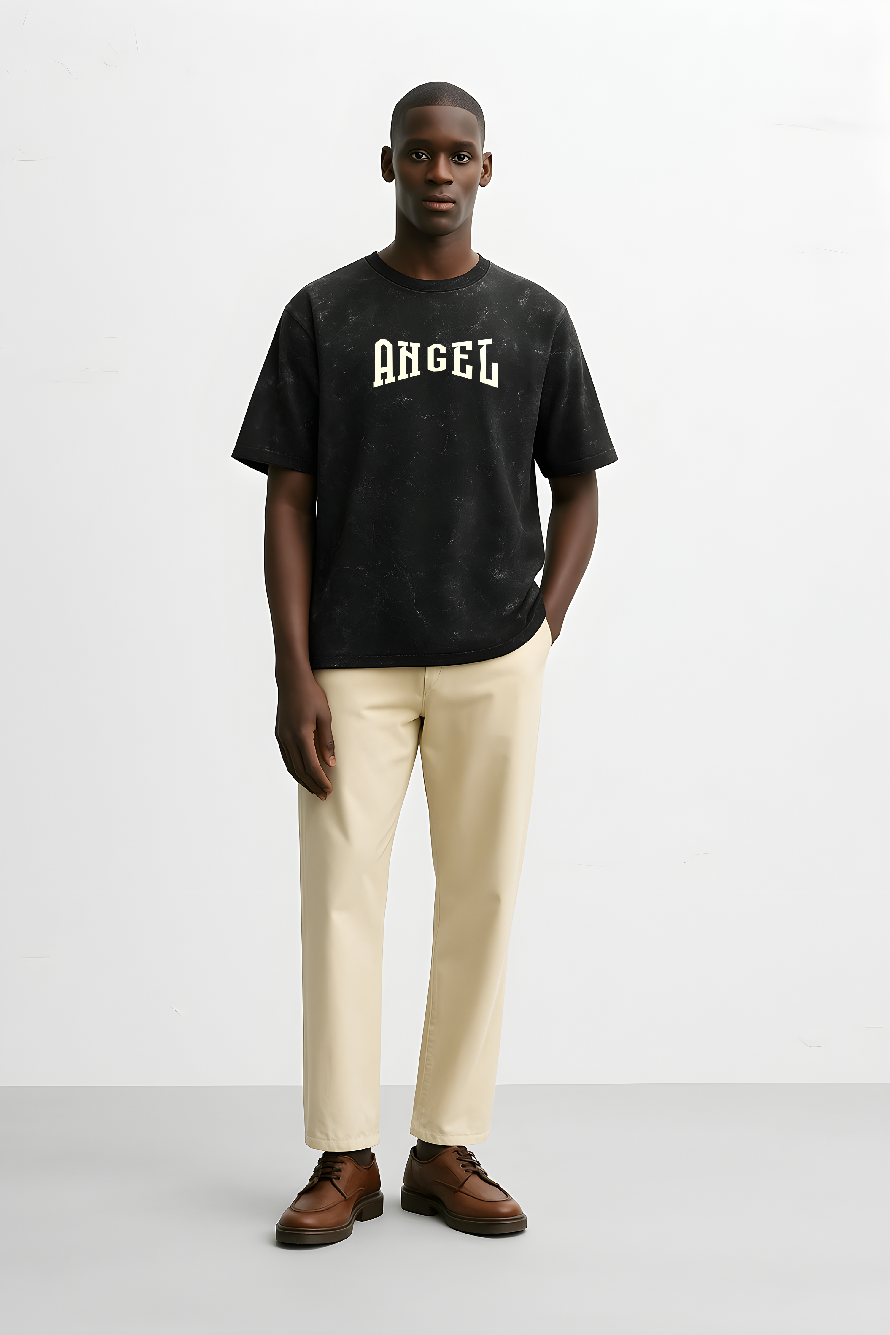 Man wearing a vintage angelic oversized shirt in black with the word Angel printed on it