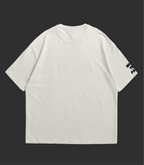 Back view of WHAT THE FATE water lilies oversize tee in light color with printed sleeve detail