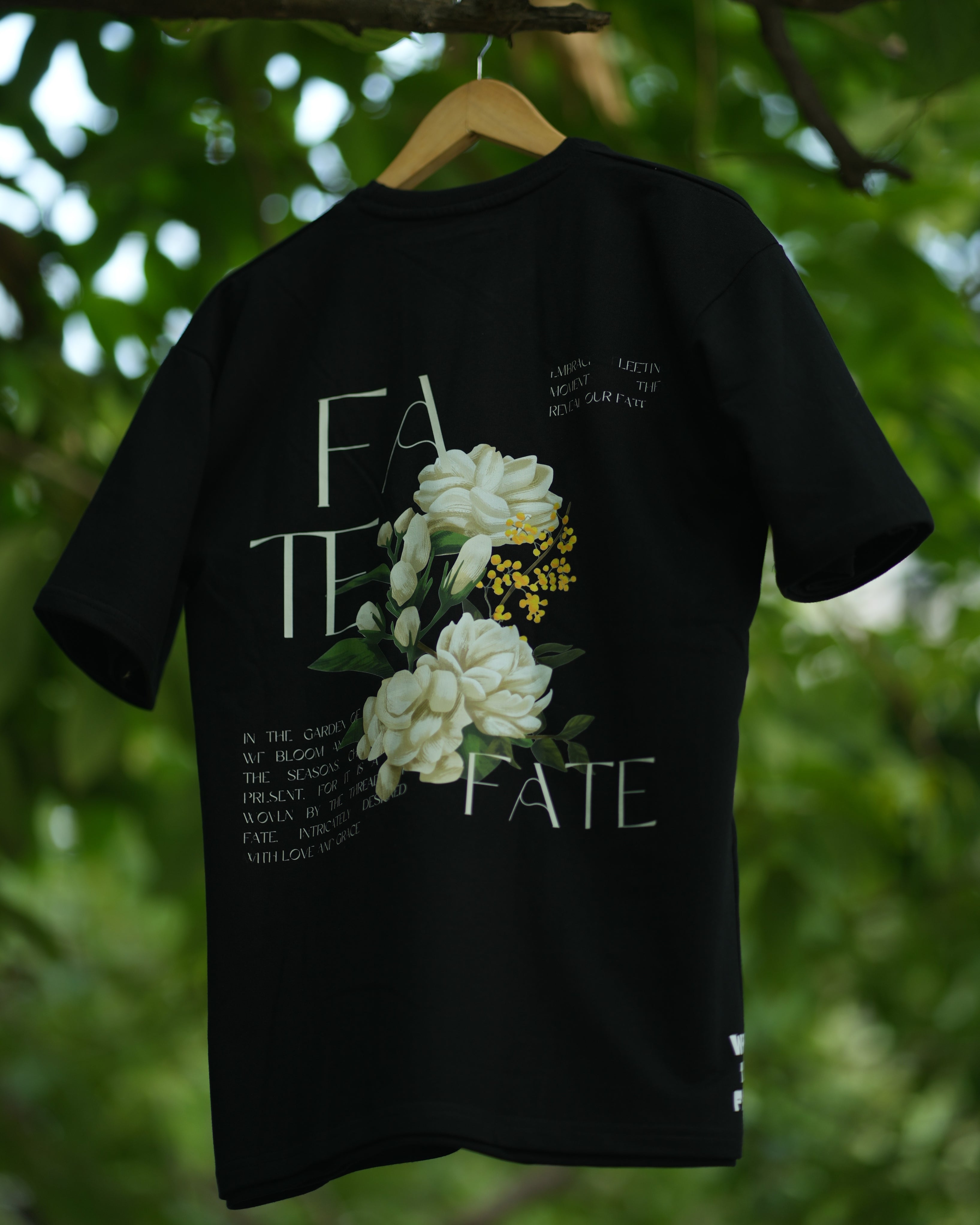 Black oversized FATE floral graphic t-shirt featuring bold floral design and artistic text